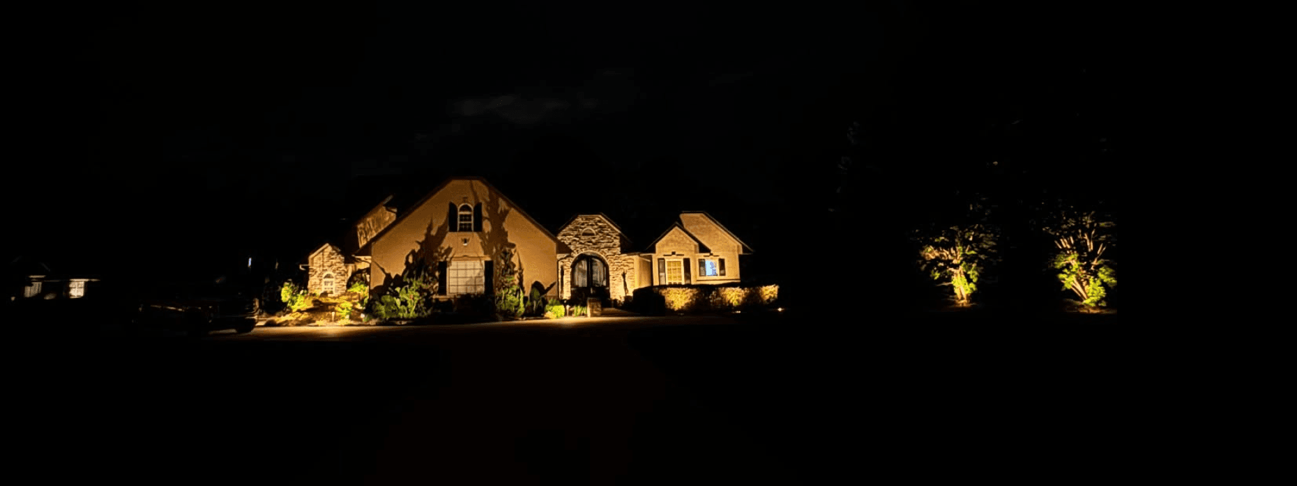 Stone estate with comprehensive landscape lighting
