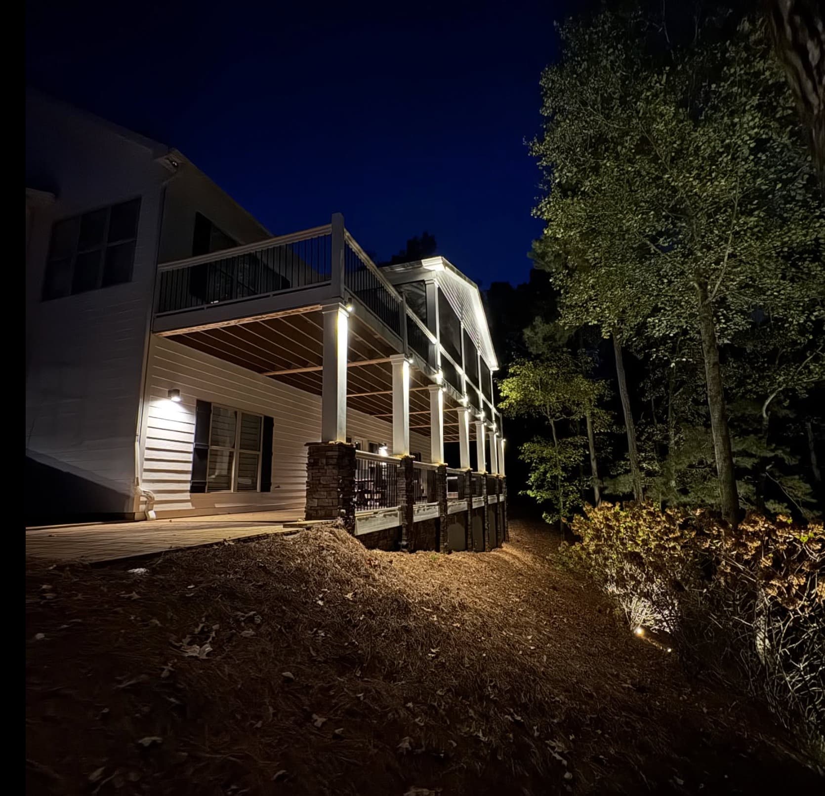 Multi-level hillside deck with column lighting