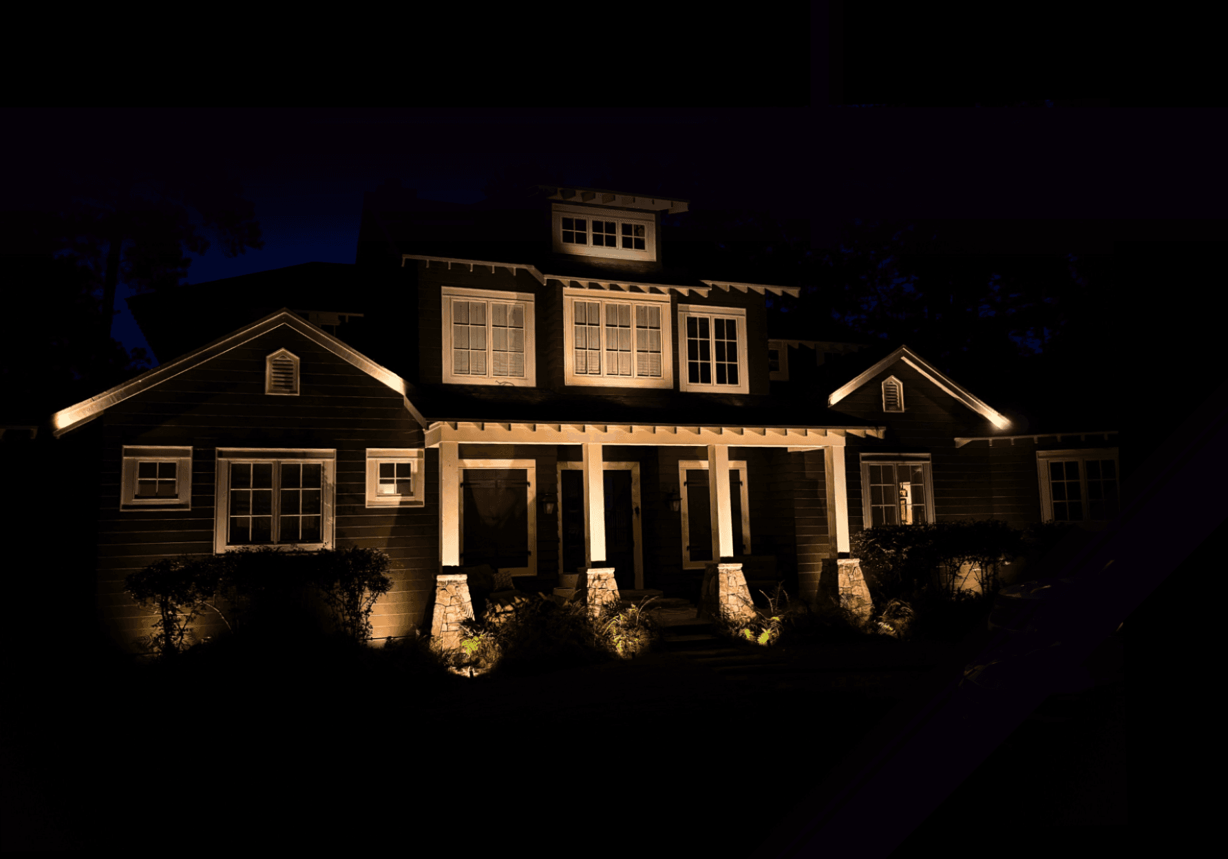 Craftsman-style home with warm porch and facade lighting